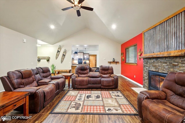 6325 S Hayfield Rd, Wasilla, AK 99654 - living area with ceiling fan, wood finished floors, lofted ceiling, and a stone fireplace