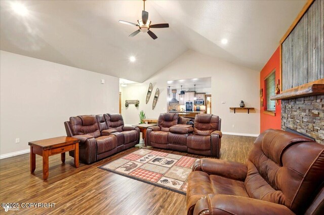 6325 S Hayfield Rd, Wasilla, AK 99654 - living room with a ceiling fan, wood finished floors, vaulted ceiling, and baseboards