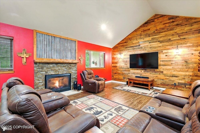 6325 S Hayfield Rd, Wasilla, AK 99654 - living room with wood walls, wood finished floors, high vaulted ceiling, healthy amount of natural light, and a stone fireplace