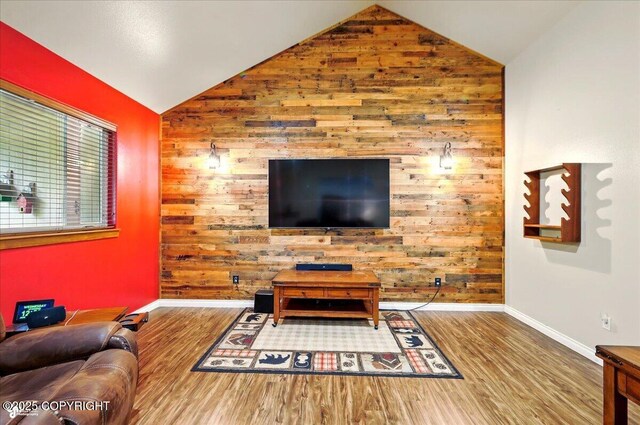 6325 S Hayfield Rd, Wasilla, AK 99654 - living room with wood finished floors, baseboards, lofted ceiling, and wooden walls