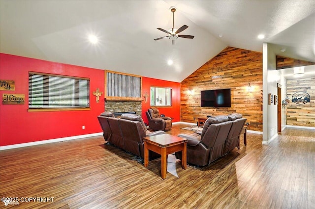 6325 S Hayfield Rd, Wasilla, AK 99654 - living room with a ceiling fan, a fireplace, wood finished floors, wood walls, and baseboards