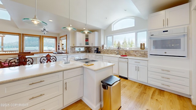 22 Sing Lee Aly # 5, Petersburg, AK 99833 - kitchen with white appliances, lofted ceiling, a sink, decorative backsplash, and light countertops