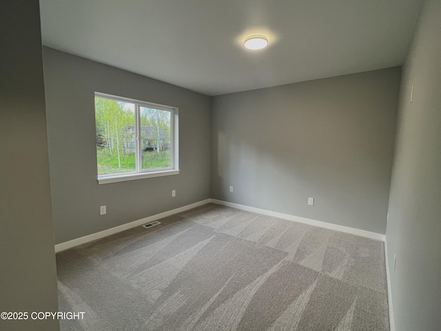 8201 W Teal Cir, Wasilla, AK 99623 - spare room featuring baseboards and carpet floors