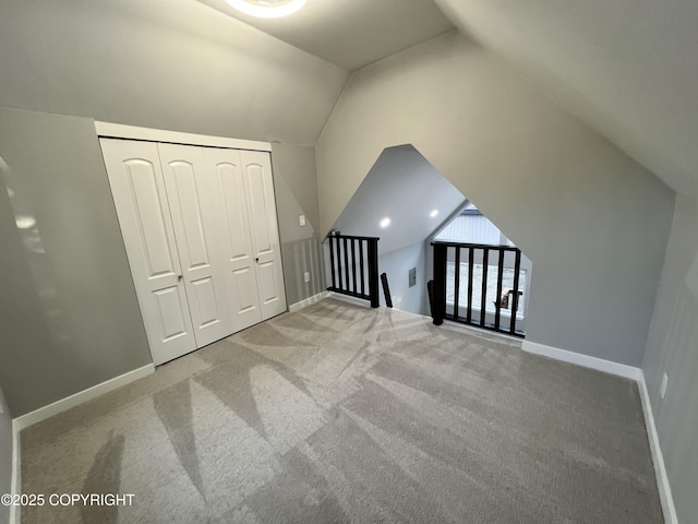 8201 W Teal Cir, Wasilla, AK 99623 - additional living space with lofted ceiling, carpet flooring, and baseboards