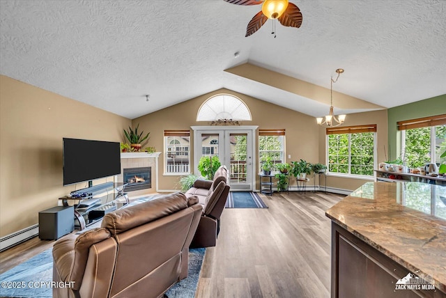 11736 Galloway Loop # 22, Eagle River, AK 99577 - living room with vaulted ceiling, light wood-style floors, ceiling fan, a textured ceiling, and a glass covered fireplace