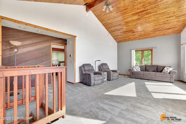 15245 Longbow Dr, Anchorage, AK 99516 - carpeted living area featuring wood ceiling with exposed beams, high vaulted ceiling, and baseboards
