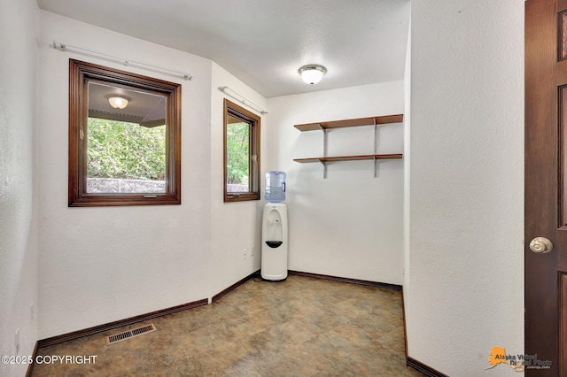15245 Longbow Dr, Anchorage, AK 99516 - laundry room with baseboards and tile patterned floors