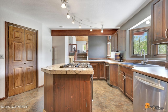 15245 Longbow Dr, Anchorage, AK 99516 - kitchen with stainless steel appliances, a sink, light countertops, a kitchen island, and light floors