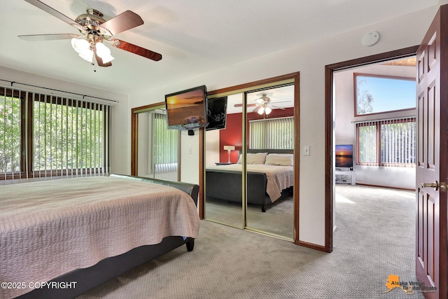 15245 Longbow Dr, Anchorage, AK 99516 - carpeted bedroom with multiple windows, two closets, and ceiling fan