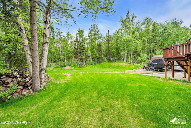19705 Citation Rd, Eagle River, AK 99577 - view of grassy yard with a deck