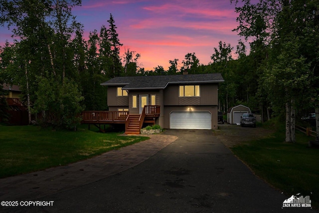 19705 Citation Rd, Eagle River, AK 99577 - raised ranch with driveway, an attached garage, a front lawn, and a deck
