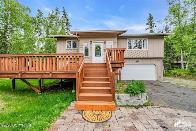 19705 Citation Rd, Eagle River, AK 99577 - view of front of house featuring a garage, asphalt driveway, and a deck
