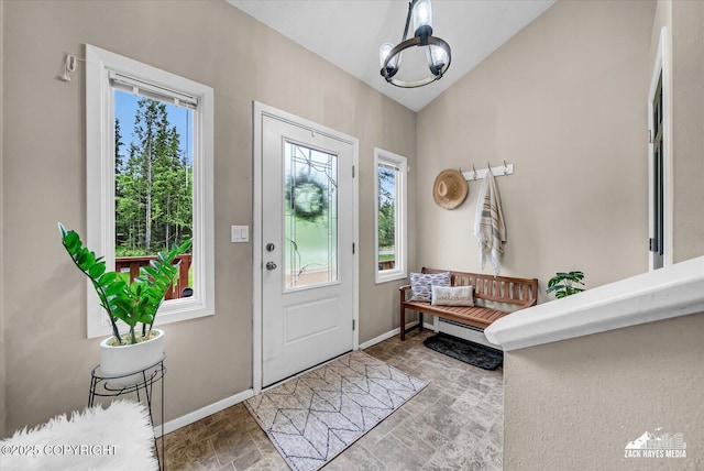 19705 Citation Rd, Eagle River, AK 99577 - entryway featuring healthy amount of natural light, stone finish floors, baseboards, vaulted ceiling, and a chandelier