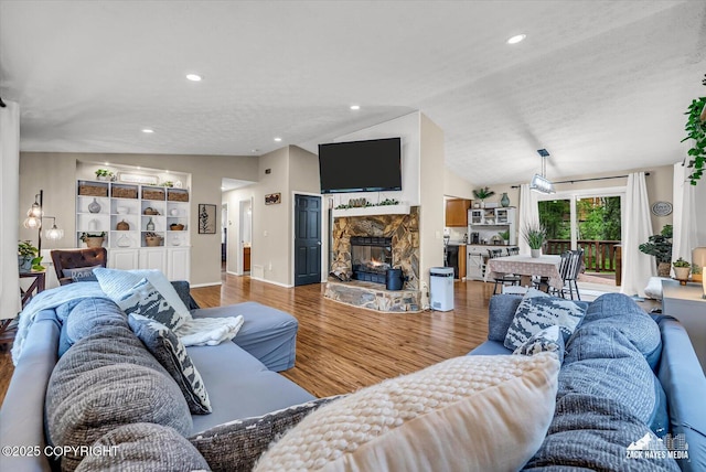 19705 Citation Rd, Eagle River, AK 99577 - living area featuring wood finished floors, lofted ceiling, and a fireplace