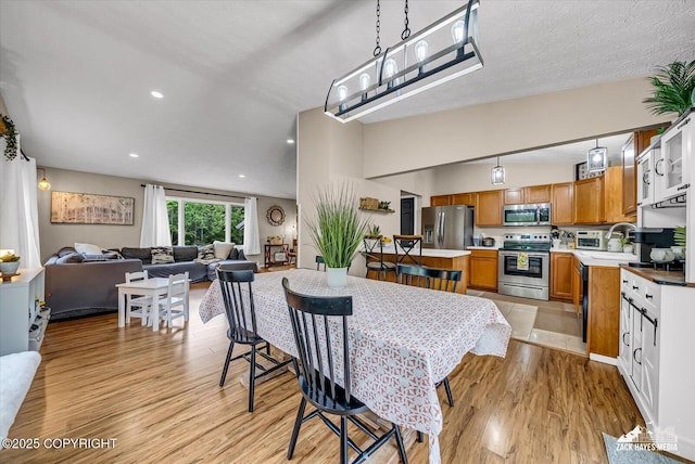 19705 Citation Rd, Eagle River, AK 99577 - dining area featuring light wood finished floors and recessed lighting