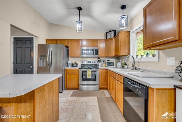 19705 Citation Rd, Eagle River, AK 99577 - kitchen with stainless steel appliances, a sink, vaulted ceiling, light countertops, and brown cabinetry