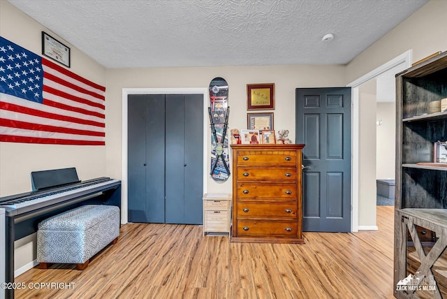 19705 Citation Rd, Eagle River, AK 99577 - sitting room featuring wood finished floors and a textured ceiling