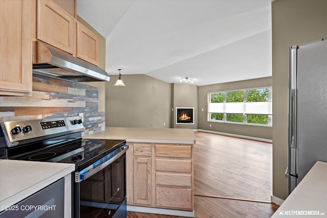 7616 Boundary Ave, Anchorage, AK 99504 - kitchen with appliances with stainless steel finishes, under cabinet range hood, lofted ceiling, light brown cabinetry, and light countertops