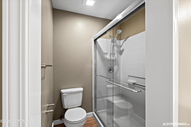 7616 Boundary Ave, Anchorage, AK 99504 - bathroom featuring toilet, a shower stall, and wood finished floors