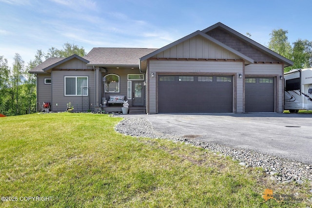 5844 E Fetlock Dr, Wasilla, AK 99654 - view of front of property featuring driveway, an attached garage, a front yard, board and batten siding, and a shingled roof