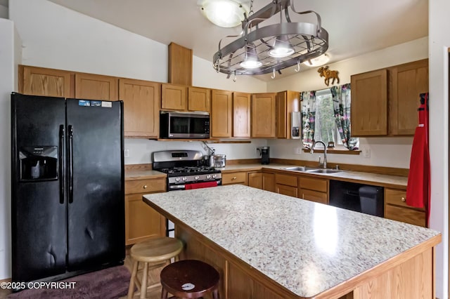 3535 S Robert Lile Cir, Palmer, AK 99645 - kitchen featuring black appliances, a sink, light countertops, a center island, and a breakfast bar area