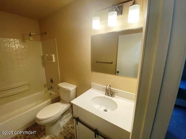 3301 Pussywillow St, Anchorage, AK 99504 - full bathroom featuring toilet, tub / shower combination, vanity, a textured wall, and tile patterned floors