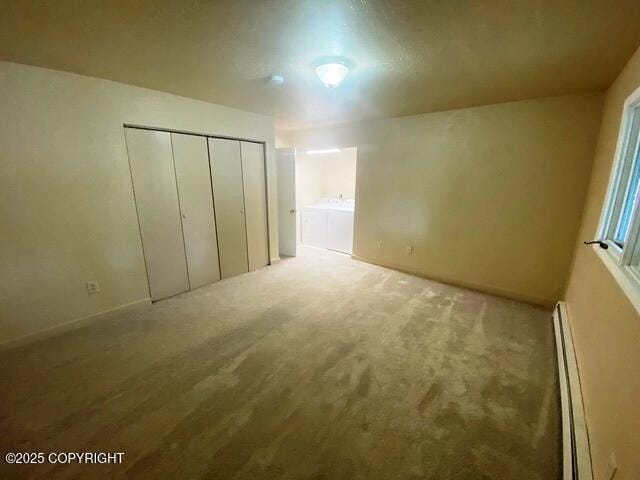 3301 Pussywillow St, Anchorage, AK 99504 - unfurnished bedroom with independent washer and dryer, baseboard heating, carpet floors, a closet, and baseboards
