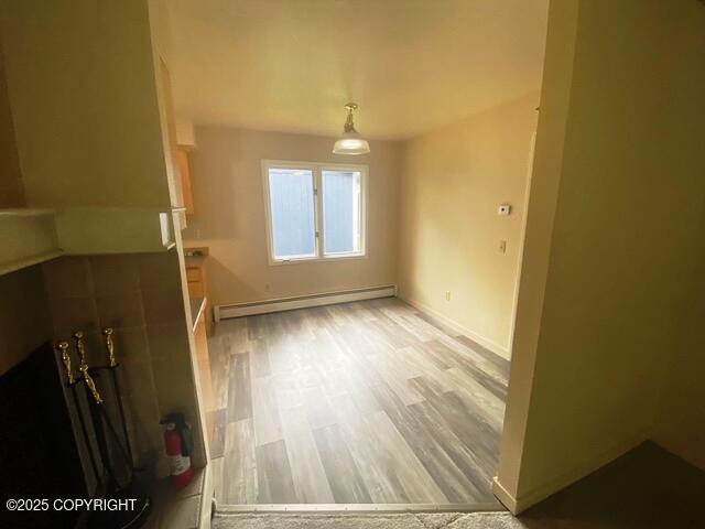 3301 Pussywillow St, Anchorage, AK 99504 - spare room featuring baseboard heating, baseboards, and light wood-style floors