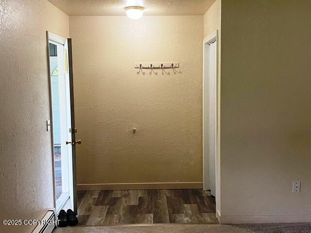 3301 Pussywillow St, Anchorage, AK 99504 - hallway with wood finished floors, a textured wall, and baseboards