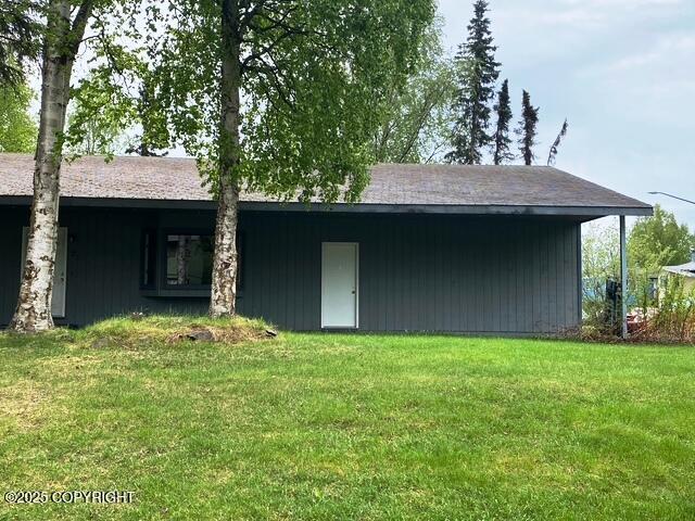3301 Pussywillow St, Anchorage, AK 99504 - rear view of house featuring a yard