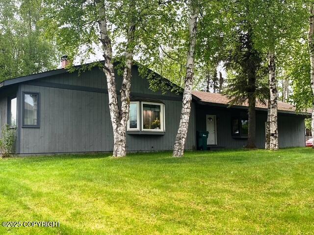 3301 Pussywillow St, Anchorage, AK 99504 - view of front of house featuring a front yard and a chimney