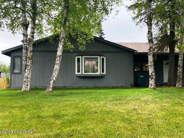 3301 Pussywillow St, Anchorage, AK 99504 - view of side of property with a yard