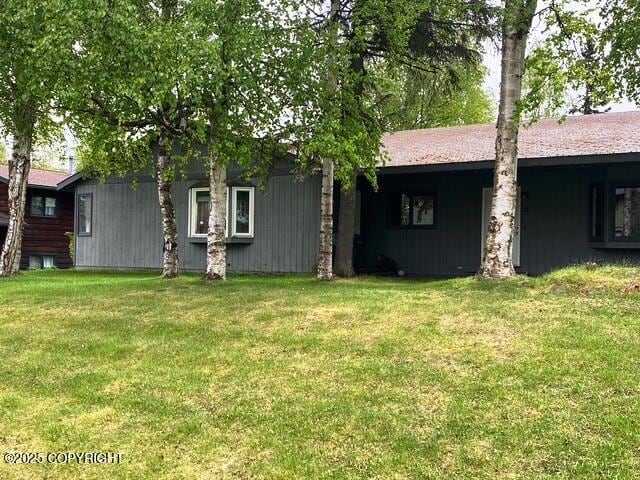 3301 Pussywillow St, Anchorage, AK 99504 - rear view of house featuring a lawn