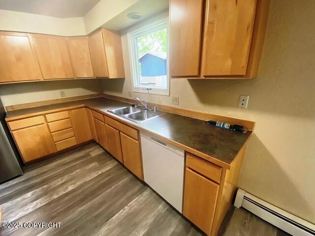 3301 Pussywillow St, Anchorage, AK 99504 - kitchen with white dishwasher, baseboard heating, a sink, light brown cabinetry, and wood finished floors