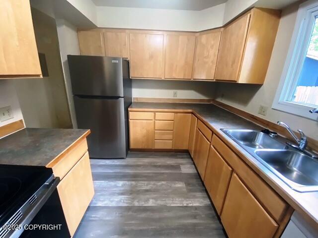 3301 Pussywillow St, Anchorage, AK 99504 - kitchen with freestanding refrigerator, a sink, wood finished floors, light brown cabinetry, and black range with electric stovetop