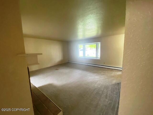 3301 Pussywillow St, Anchorage, AK 99504 - empty room with a textured wall and a baseboard radiator