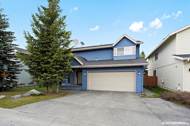 1503 N Heather Meadows Loop Unit 54, Anchorage, AK 99507 - view of front of house featuring driveway and an attached garage