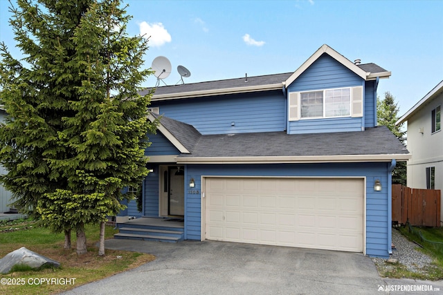 1503 N Heather Meadows Loop Unit 54, Anchorage, AK 99507 - view of front facade with asphalt driveway and a garage