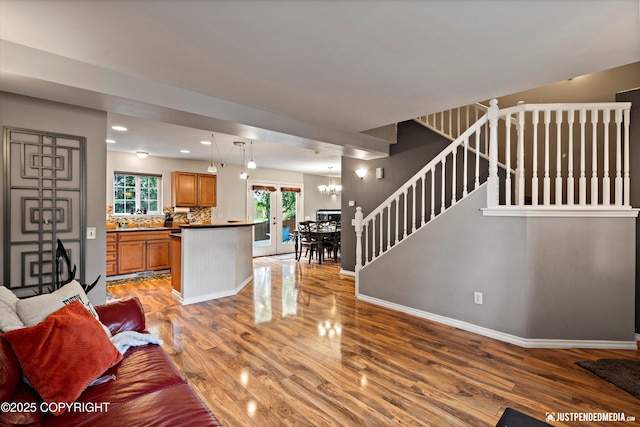 1503 N Heather Meadows Loop Unit 54, Anchorage, AK 99507 - living room with light wood-type flooring, stairs, baseboards, a chandelier, and recessed lighting