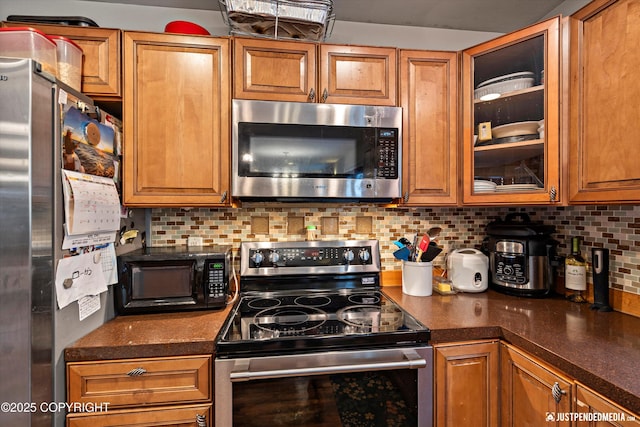 1503 N Heather Meadows Loop Unit 54, Anchorage, AK 99507 - kitchen featuring appliances with stainless steel finishes, brown cabinetry, and dark countertops