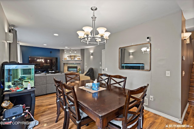 1503 N Heather Meadows Loop Unit 54, Anchorage, AK 99507 - dining room featuring a chandelier, wood finished floors, a tile fireplace, baseboards, and recessed lighting