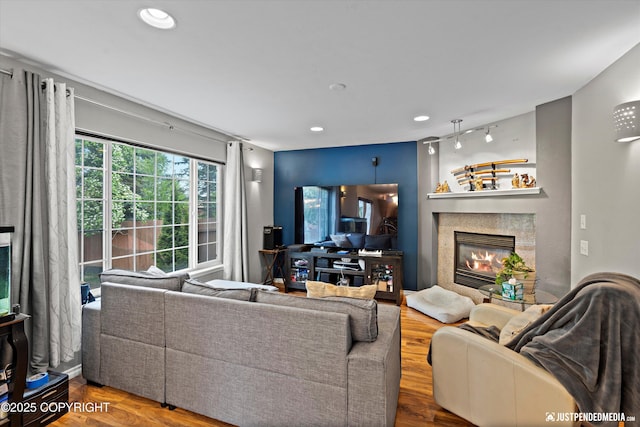 1503 N Heather Meadows Loop Unit 54, Anchorage, AK 99507 - living room featuring a tiled fireplace, recessed lighting, and wood finished floors