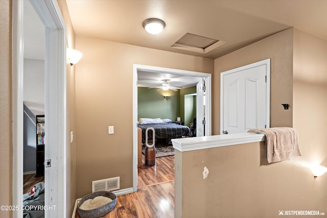 1503 N Heather Meadows Loop Unit 54, Anchorage, AK 99507 - corridor featuring light wood-style floors, attic access, and baseboards