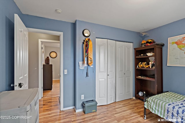 1503 N Heather Meadows Loop Unit 54, Anchorage, AK 99507 - bedroom with light wood-style flooring, a closet, and baseboards