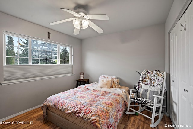 1503 N Heather Meadows Loop Unit 54, Anchorage, AK 99507 - bedroom featuring a closet, wood finished floors, baseboards, and ceiling fan