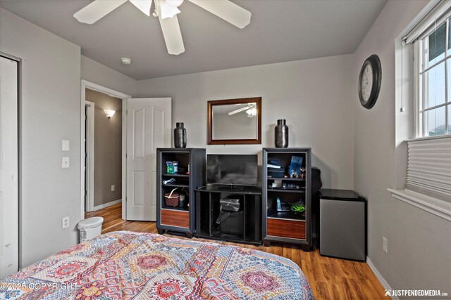 1503 N Heather Meadows Loop Unit 54, Anchorage, AK 99507 - bedroom featuring wood finished floors, ceiling fan, and baseboards