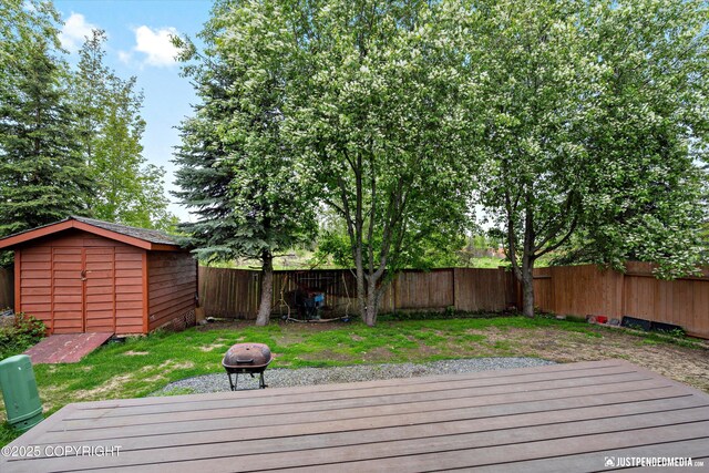 1503 N Heather Meadows Loop Unit 54, Anchorage, AK 99507 - wooden deck featuring a fenced backyard and an outdoor fire pit