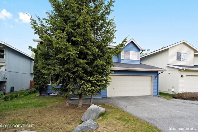 1503 N Heather Meadows Loop Unit 54, Anchorage, AK 99507 - view of front of home featuring a garage, asphalt driveway, and a front lawn