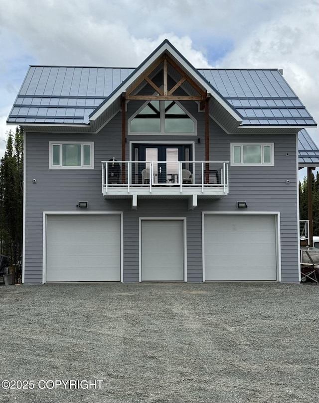 36229 Bradford Rd, Sterling, AK 99672 - rear view of property with a standing seam roof, a garage, a balcony, and metal roof