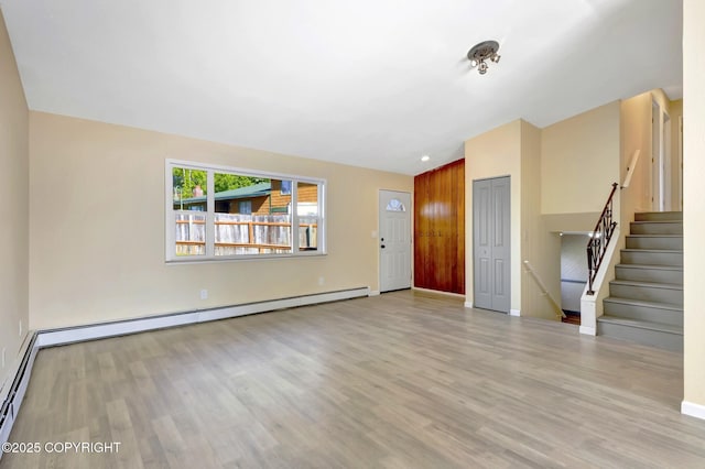 4665 Cascade Cir, Anchorage, AK 99502 - entryway featuring wood finished floors, baseboards, stairs, and baseboard heating